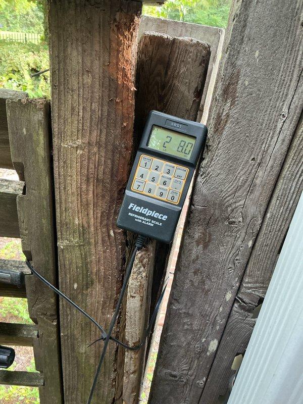 Responded to no cooling call for two 10+ year old units located in side yard. Upon arrival, found both systems unable to maintain set temperature as reported. Performed diagnostic evaluation on both units using digital meter to check system pressures and operational parameters. Reading of 29.80 indicates low refrigerant charge on at least one system. Inspected indoor components including copper refrigerant lines, PVC condensate drain, and associated mechanical infrastructure in utility area. Both systems showed signs of age-related wear with tarnished copper piping and general deterioration. Units had been shut off per prior instruction. Documented equipment condition and diagnostic findings with photos. Provided customer with repair recommendations to restore proper cooling operation for both units.