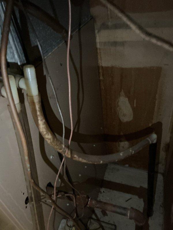 Responded to no cooling call for two 10+ year old units located in side yard. Upon arrival, found both systems unable to maintain set temperature as reported. Performed diagnostic evaluation on both units using digital meter to check system pressures and operational parameters. Reading of 29.80 indicates low refrigerant charge on at least one system. Inspected indoor components including copper refrigerant lines, PVC condensate drain, and associated mechanical infrastructure in utility area. Both systems showed signs of age-related wear with tarnished copper piping and general deterioration. Units had been shut off per prior instruction. Documented equipment condition and diagnostic findings with photos. Provided customer with repair recommendations to restore proper cooling operation for both units.