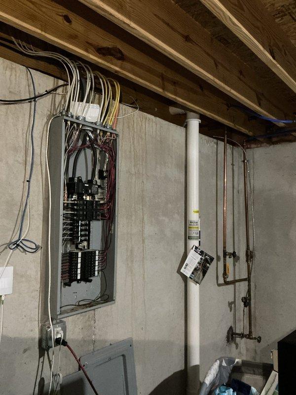 Conducted comprehensive electrical inspection of basement utility area to assess potential water damage from reported leak. Thoroughly examined 200-amp main electrical panel, all circuit breakers, and associated wiring throughout the space. Inspected all electrical conductors, connections, and panel interior for signs of moisture intrusion, corrosion, or water-related deterioration. Documented current condition of electrical system with photographs showing panel configuration, wire routing, and overall installation. All findings photographed and prepared for review with customer contact regarding inspection results.