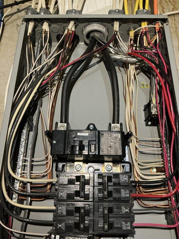 Conducted comprehensive electrical inspection of basement utility area to assess potential water damage from reported leak. Thoroughly examined 200-amp main electrical panel, all circuit breakers, and associated wiring throughout the space. Inspected all electrical conductors, connections, and panel interior for signs of moisture intrusion, corrosion, or water-related deterioration. Documented current condition of electrical system with photographs showing panel configuration, wire routing, and overall installation. All findings photographed and prepared for review with customer contact regarding inspection results.