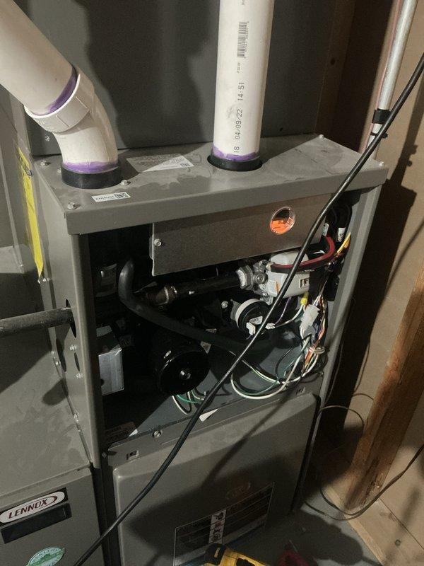 Completed comprehensive heating and cooling tune-up on Lennox furnace unit located in basement. Performed full system inspection including blower assembly, electrical connections, and internal components with access panel removed for thorough evaluation. Verified proper operation of PVC intake and exhaust venting system. Inspected and tested Aprilaire humidistat and PRO digital thermostat for proper functionality and calibration. System found to be operating within normal parameters with all components functioning as designed.