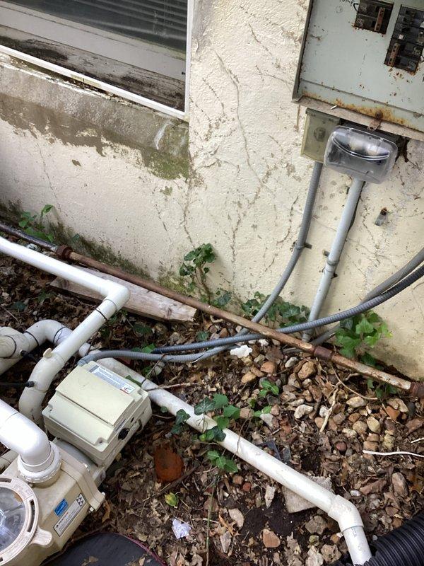 Responded to follow-up service call for pool electrical system issues. Adjusted and secured outlet boxes in the pool area that had become misaligned. Replaced damaged electrical conduit casing and junction box components showing significant weathering and deterioration. Inspected exterior electrical installations including meter enclosure, conduit runs, and associated wiring connections. Verified proper grounding and secure mounting of all electrical fixtures. Documented existing conditions including aged stucco surface, deteriorated protective covers on junction boxes, and gray flexible conduit connections to pool pump system. All electrical components tested and confirmed operational upon completion.