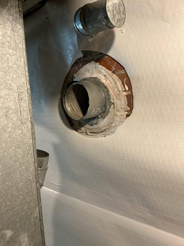 Responded to service call regarding improper flue pipe penetration through wall requiring clearance correction. Upon inspection, identified metal flue pipe penetrating through wall surface with inadequate clearance and significant rust staining indicating long-term corrosion and moisture exposure. Flue pipe lacked proper thimble installation to maintain required clearance from combustible materials per code requirements. Documented existing conditions showing corroded pipe threading, deteriorated wall penetration, and improper installation that poses potential safety hazard. Provided quote for installation of raised thimble assembly to establish proper clearance between flue pipe and surrounding combustible wall materials, ensuring code-compliant installation for real estate transaction requirements.