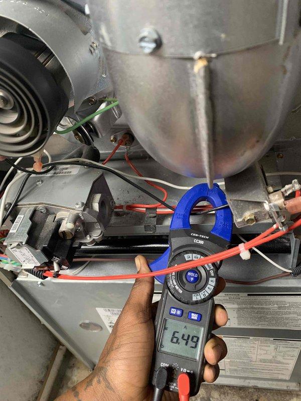 Completed comprehensive HVAC tune-up and maintenance on a 6-year-old air conditioning system and 11-year-old furnace, both operating properly at time of service. Performed diagnostic testing using clamp meter to verify electrical current readings on blower motor assembly (649 amp reading) and refrigerant line measurements (14.5 reading), inspected all mechanical components including heat exchanger, blower wheel, control board connections, and electrical wiring throughout the system. All components found to be functioning within normal parameters with no deficiencies noted.