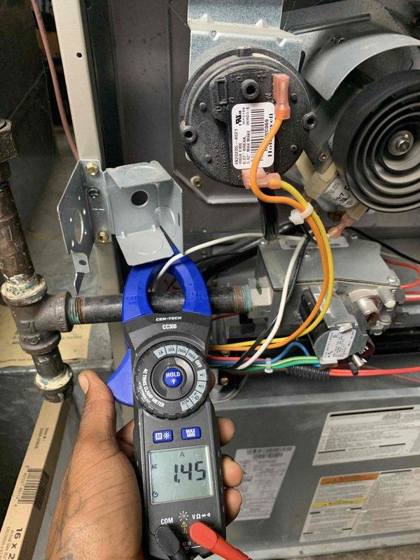 Completed comprehensive HVAC tune-up and maintenance on a 6-year-old air conditioning system and 11-year-old furnace, both operating properly at time of service. Performed diagnostic testing using clamp meter to verify electrical current readings on blower motor assembly (649 amp reading) and refrigerant line measurements (14.5 reading), inspected all mechanical components including heat exchanger, blower wheel, control board connections, and electrical wiring throughout the system. All components found to be functioning within normal parameters with no deficiencies noted.