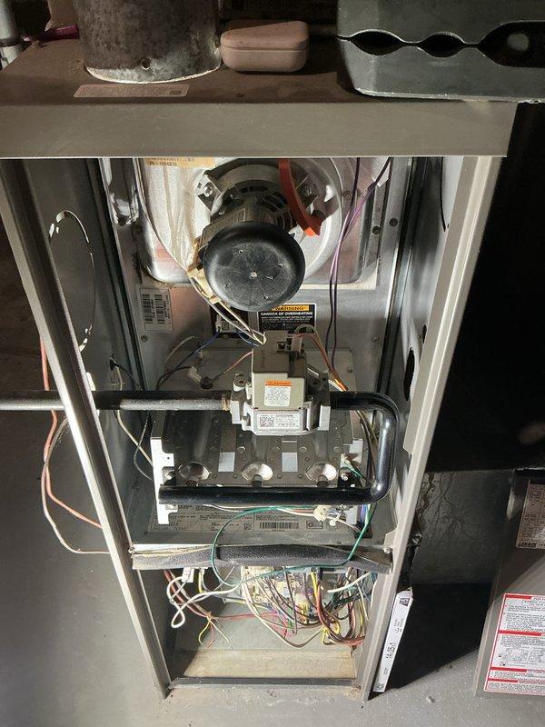 Completed comprehensive O10 furnace tune-up in basement location per Home Depot promotional service agreement. Performed full system inspection including blower motor assembly, gas valve, electrical connections, and internal components with access panel removed for thorough evaluation. Verified Honeywell Home thermostat operation showing proper heating mode function with setpoint at 71°F and current temperature reading of 75°F, confirming system cycling and fan auto operation as designed.