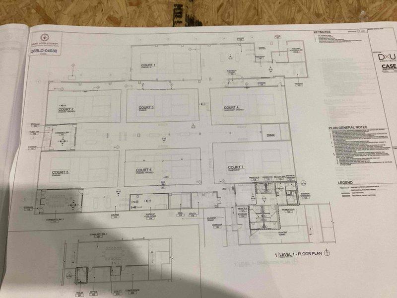 Reviewed architectural and electrical power plans for a multi-court sports facility featuring seven individual courts with supporting auxiliary spaces. Documented permit set electrical drawings including power distribution layouts, general electrical notes, and specifications for the entire property. Updated project timeline to 8-12 week timeframe and captured photographic documentation of construction plans for comprehensive electrical estimate preparation.