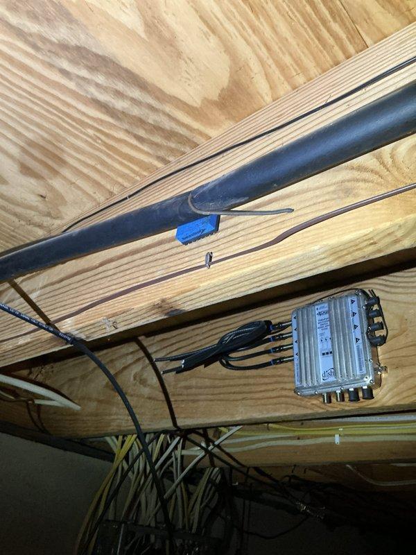 Responded to service call for 9-year-old air conditioning unit experiencing loud booming noise upon startup. Performed diagnostic inspection of basement-mounted system and associated ductwork infrastructure. Inspected refrigerant lines, electrical connections, and mounting hardware in crawl space area to identify source of abnormal sound. Documented existing conditions of copper line sets, electrical junction boxes, and structural mounting points with photographic evidence for service records.