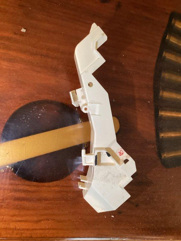 Responded to service call for squeaking mini split system. Upon inspection, identified broken mounting clip/bracket component that was damaged during previous service visit. Replaced defective white plastic mounting bracket assembly with new part to restore proper unit operation and eliminate noise issue.