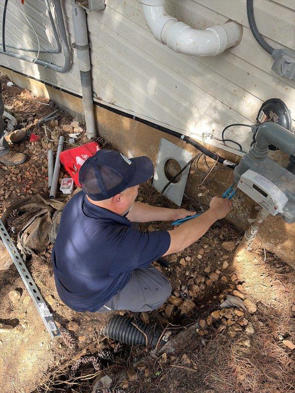 Completed installation of a 20kW Kohler standby generator on a newly poured concrete pad. Ran 3/4" TracPipe from the meter tap down the foundation to the concrete pad, then transitioned to 3/4" black iron pipe across the pad to the generator unit, securing all piping to the concrete using Unistrut and clamps. Installed gas regulator at the unit with shutoff valve, sediment trap, and flexible connector to ensure proper fuel delivery and system safety.