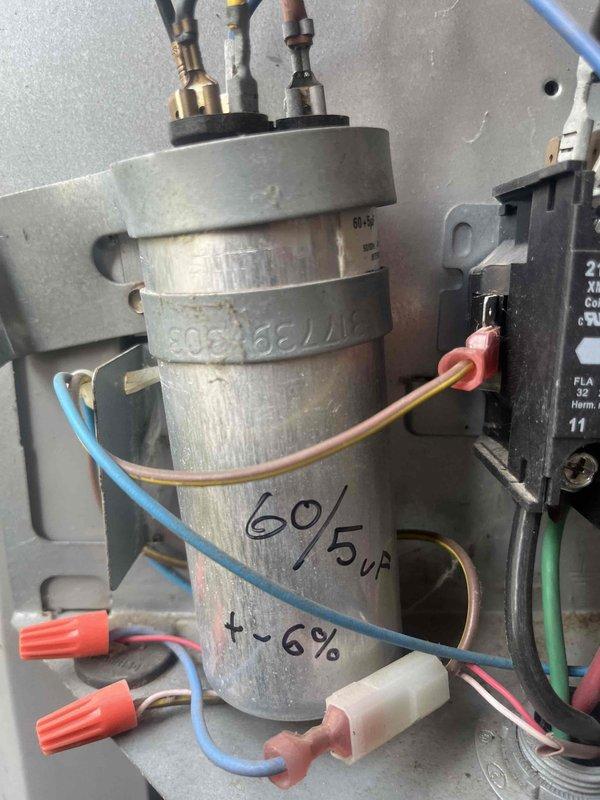 Completed comprehensive tune-up and maintenance on single air conditioning unit located in side yard. Performed standard preventive maintenance procedures including inspection of dual-run capacitor (60/5µF) and electrical connections, verification of proper wire terminations and contactor operation, and assessment of overall system components. Inspected associated basement furnace and ductwork infrastructure. Upon initial service notes indicating small leak concern, conducted thorough examination of refrigerant lines and connections; documented system condition with photos of electrical panel components and mechanical room layout for service records.