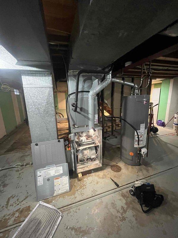Completed comprehensive tune-up and maintenance on single air conditioning unit located in side yard. Performed standard preventive maintenance procedures including inspection of dual-run capacitor (60/5µF) and electrical connections, verification of proper wire terminations and contactor operation, and assessment of overall system components. Inspected associated basement furnace and ductwork infrastructure. Upon initial service notes indicating small leak concern, conducted thorough examination of refrigerant lines and connections; documented system condition with photos of electrical panel components and mechanical room layout for service records.