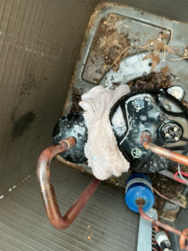 Replaced failed compressor on residential air conditioning system. Removed and disposed of old compressor showing signs of corrosion and deterioration, installed new replacement unit, brazed copper line connections, performed vacuum and leak test, recharged system with refrigerant to manufacturer specifications, and verified proper operation with temperature differential readings confirming system cooling at 35.5°F supply temperature. Unit tested and operational upon departure.