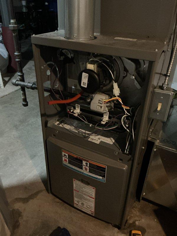 Completed comprehensive tune-up service on a 3-year-old residential gas furnace located in basement. Performed full system inspection including blower motor operation, electrical connections, combustion chamber assessment, and venting components. Verified thermostat functionality and proper communication with heating unit, confirmed all safety labels and manufacturer specifications were intact and legible, and documented system condition with photos for service records.
