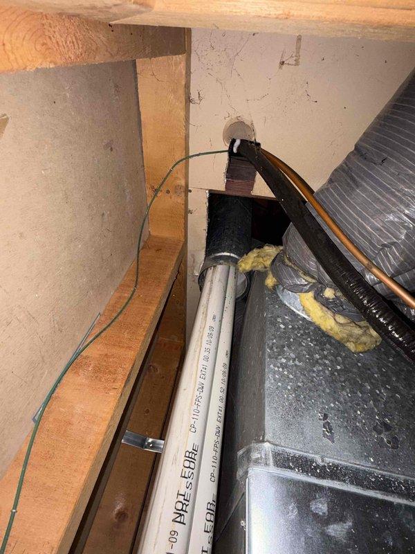 # HVAC Service Completed

Responded to no cooling call for 10+ year old residential unit located on side of home. Upon arrival, performed system diagnostics and inspection of both indoor and outdoor components. Accessed attic space to examine air handler and ductwork connections. 

Found system had stopped operating due to equipment failure. Inspected flexible ductwork, PVC condensate drain line, and electrical connections in confined attic space. Verified proper insulation placement around duct components and checked for any airflow restrictions. 

Examined blower assembly and associated wiring in crawlspace area beneath unit. Tested electrical connections and verified proper voltage at equipment. Inspected condensate pump operation and drainage system functionality, including all piping and fittings.

Documented existing conditions with photos showing HVAC components, ductwork configuration, and mechanical equipment layout. System restored to proper cooling operation following diagno
