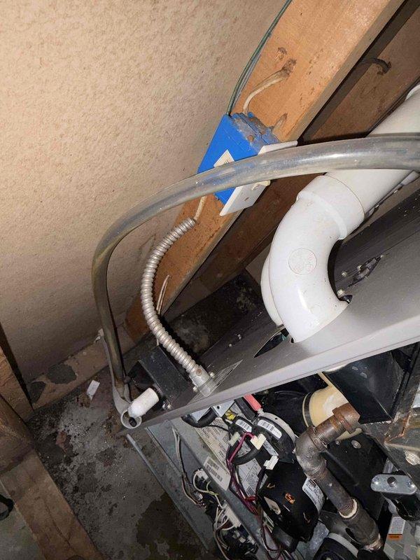 # HVAC Service Completed

Responded to no cooling call for 10+ year old residential unit located on side of home. Upon arrival, performed system diagnostics and inspection of both indoor and outdoor components. Accessed attic space to examine air handler and ductwork connections. 

Found system had stopped operating due to equipment failure. Inspected flexible ductwork, PVC condensate drain line, and electrical connections in confined attic space. Verified proper insulation placement around duct components and checked for any airflow restrictions. 

Examined blower assembly and associated wiring in crawlspace area beneath unit. Tested electrical connections and verified proper voltage at equipment. Inspected condensate pump operation and drainage system functionality, including all piping and fittings.

Documented existing conditions with photos showing HVAC components, ductwork configuration, and mechanical equipment layout. System restored to proper cooling operation following diagno