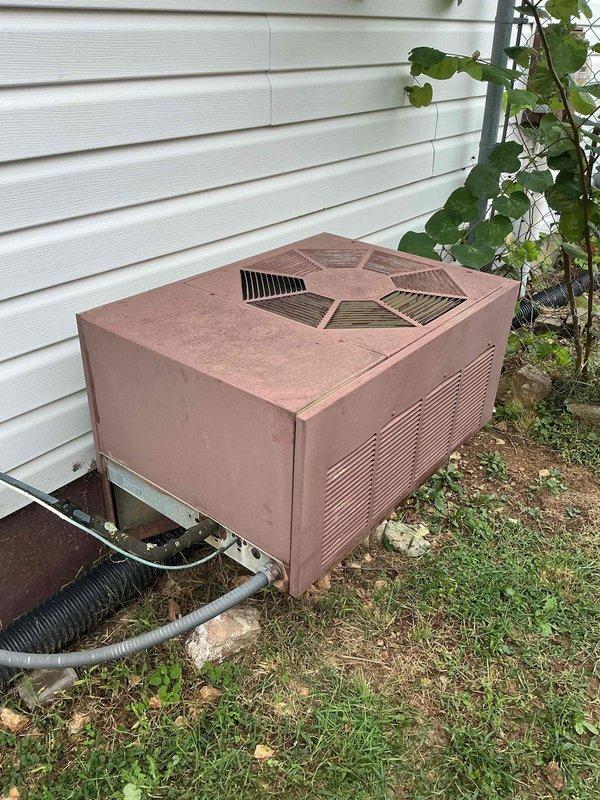 Responded to no cooling complaint on residential air conditioning system. Upon arrival, found aging outdoor condensing unit with cabinet panels removed for inspection. Visual assessment revealed extensive weathering, corrosion, and dirt accumulation on internal components including compressor housing, refrigerant lines, and electrical connections. Unit exhibited significant oxidation on metal surfaces and deteriorated cabinet finish consistent with extended outdoor exposure. Documented equipment condition with photographs showing internal mechanical components, copper refrigerant tubing, and overall system degradation. Based on age and visible wear of equipment, provided assessment findings to customer regarding cooling system performance issues.