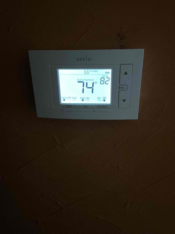 Performed comprehensive tune-up and maintenance on a 2-year-old Lennox air conditioning system operating within normal parameters. Inspected air filter in attic air handler, which showed moderate dust accumulation consistent with normal usage; verified proper installation and secure mounting within filter housing. Confirmed Sensi thermostat functionality with accurate temperature readings at 74°F and system controls responding appropriately in off mode.
