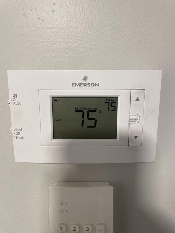 Responded to report of heat kit tripping breaker on basement AC unit. Inspected electrical panel and verified 30-amp breaker serving the air handler was experiencing overload condition. Examined thermostat operation showing cooling mode active with 75°F current temperature and 79°F setpoint. Identified heat kit as source of electrical fault causing breaker trips. Documented panel labeling indicating "Air Handler" circuit and photographed thermostat settings and breaker configuration for reference.