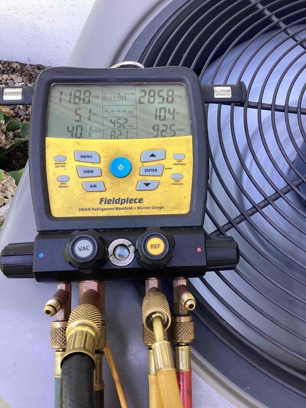 Performed comprehensive system evaluations on two HVAC units for new homeowner. Conducted diagnostic testing using refrigerant manifold and micron gauge on outdoor condensing unit, measuring system pressures, temperatures, and refrigerant levels to assess operational performance. Inspected indoor components including ductwork and furnace installation in basement location. Documented equipment condition through photographic records showing both exterior condensing unit with fan assembly and interior attic/crawlspace ductwork installation. Provided technical findings and recommendations to homeowner regarding current system status and future service needs for both units.