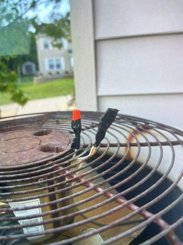 Responded to service call for outdoor condensing unit reported to be making unusual noise. Upon arrival, performed visual inspection of single residential AC unit located in side yard. Inspected condenser fan assembly and protective grille, noting significant rust and corrosion on fan guard components with visible oxidation throughout metal surfaces. Documented existing weathering and deterioration of external components. Unit operational at time of inspection. Owner approved recommended repairs to address noise concern and restore proper system function.