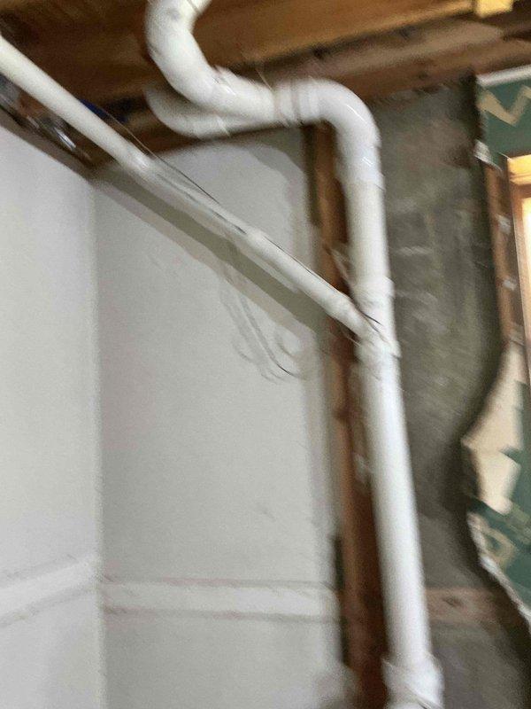 Performed comprehensive camera inspection of residential plumbing system in basement utility area. Documented white PVC drain and vent line configuration, including vertical runs with loop-style routing along interior walls, as well as horizontal piping secured to ceiling joists with proper metal clamps. Inspected blue flexible tubing and additional piping infrastructure for proper installation and condition. All photographed components showed proper installation with no visible defects or immediate concerns noted during visual assessment.