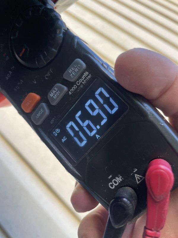 Responded to service call for 9-year-old ground-level AC unit experiencing intermittent buzzing noise occurring every 4-5 minutes. Performed diagnostic evaluation of the condenser unit and measured operating amperage at 6.90A using clamp meter to verify compressor performance and electrical draw. Unit was found operational at time of inspection; documented current conditions with no immediate repairs required at this time.