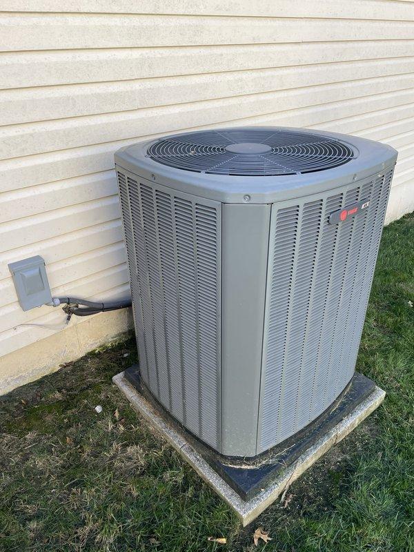 Responded to service call for 9-year-old ground-level AC unit experiencing intermittent buzzing noise occurring every 4-5 minutes. Performed diagnostic evaluation of the condenser unit and measured operating amperage at 6.90A using clamp meter to verify compressor performance and electrical draw. Unit was found operational at time of inspection; documented current conditions with no immediate repairs required at this time.