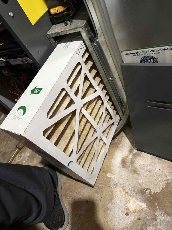 Responded to no cooling complaint on 2-year-old unit in basement. Found heavily clogged air filter restricting airflow, causing system to blow warm air. Replaced dirty filter with new filter, restoring proper airflow and cooling operation. System returned to normal function with adequate airflow and proper temperature output at thermostat reading 78°F.