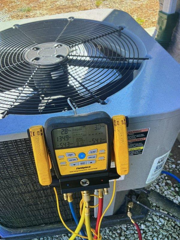 Responded to no cooling complaint on 5-year-old package unit serving 1200-1500 square foot residence. Accessed wall-mounted evaporator compartment and inspected A-frame coil assembly, copper refrigerant lines, and compressor. Connected manifold gauge set to outdoor condenser unit and performed refrigerant pressure diagnostics to evaluate system performance. Verified proper operation of condenser fan and assessed overall system functionality to restore cooling capacity.