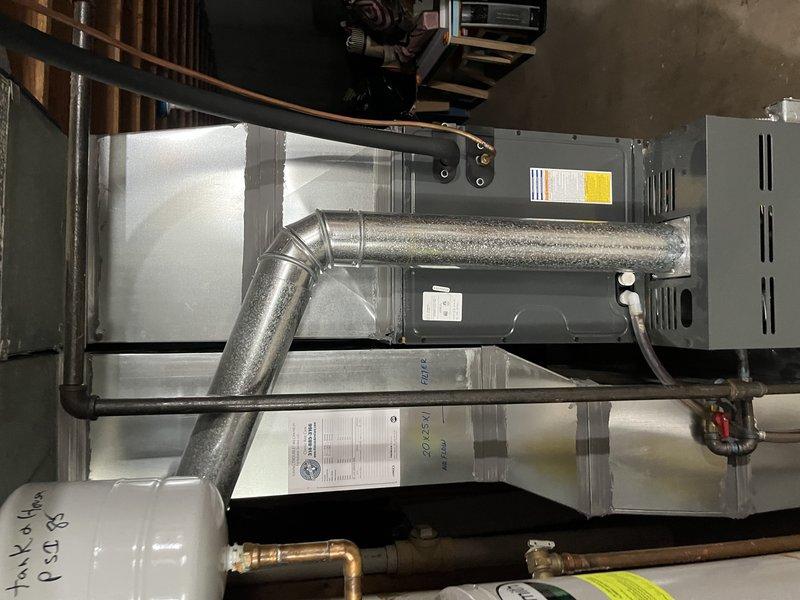 Responded to service call for loud train-like noise coming from outdoor condensing unit during AC operation. Performed diagnostic inspection of residential split system with Goodman air handler. Identified issue with outdoor unit operation and documented system configuration including refrigerant line connections, ductwork assembly, and indoor equipment installation for repair recommendations.