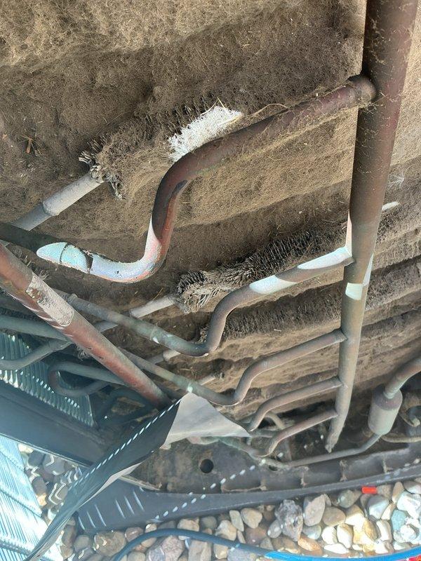 Responded to no cooling complaint on 10+ year old residential AC unit that had been shut off. Upon inspection, found evaporator coil heavily contaminated with dust, dirt, and debris accumulation, severely restricting airflow and heat transfer capability. Outdoor condenser coil also showed significant buildup of lint and fibrous material between fins, along with visible corrosion on copper refrigerant lines and deteriorated insulation on piping. Performed thorough system evaluation and documented condition of both indoor air handler and outdoor condensing unit components for repair recommendations.