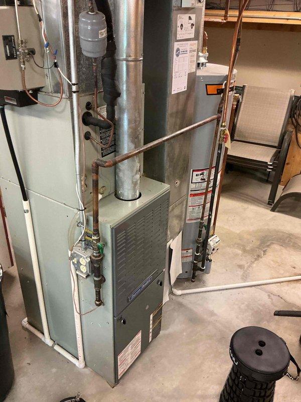 Completed comprehensive tune-up and maintenance service on a 2007 furnace unit located in basement. Performed full system inspection including visual examination of heat exchanger, burner assembly, and venting components. Conducted electrical diagnostics using clamp meter to verify proper amperage draw and system performance. Inspected and cleaned blower assembly, checked all safety controls, and verified proper operation of gas valve and ignition system. Tested system under normal operating conditions to ensure safe and efficient operation.