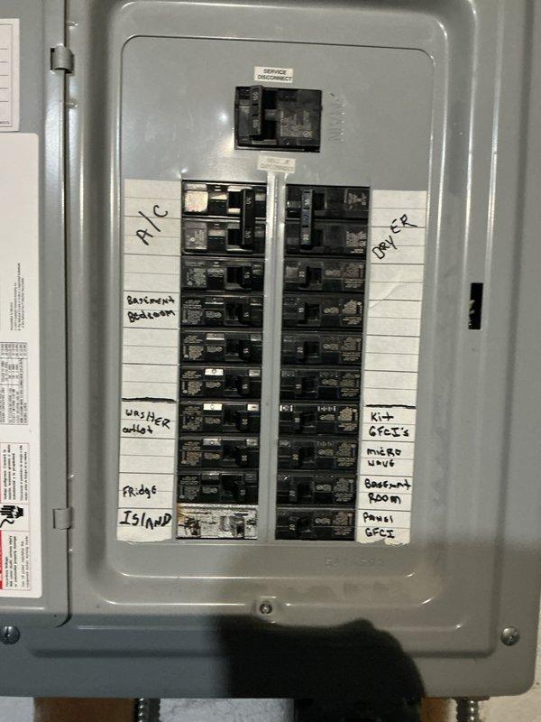 Responded to service call for outlet repair at residential property. Upon arrival, conducted comprehensive electrical system inspection and documented existing electrical panel configuration. Panel examination revealed organized circuit breaker arrangement with properly labeled circuits including dedicated lines for air conditioning, kitchen GFCI outlets, washer outlet, refrigerator, island circuits, bathrooms, bedrooms, and basement room. Verified all circuit breakers were functioning correctly, connections were secure, and wire bundling was properly maintained with appropriate cable management. Inspected grounding system and main disconnect switch for proper operation. Photographed panel interior showing wire routing, color-coded conductor organization, and circuit identification labels for service documentation. All electrical components found to be in safe operating condition with no immediate hazards identified.