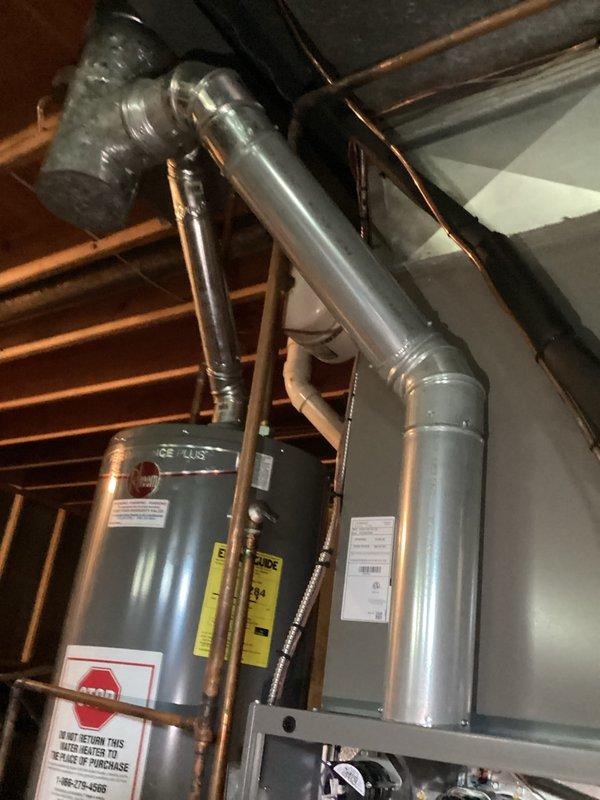 Completed preventive maintenance tune-up on basement furnace unit. Performed comprehensive inspection of blower motor assembly, noting moderate rust and corrosion present on mounting hardware and fasteners. Verified all electrical connections, checked airflow, inspected ductwork, and confirmed system operational parameters are within acceptable range for continued service.