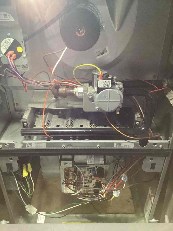 Completed comprehensive heating tune-up on 10-year-old residential furnace located in basement. Performed full system diagnostics including electrical measurements with digital multimeter, inspected blower motor assembly, gas valve operation, burner components, and control board functionality. All components found operating within normal parameters; documented system condition with photographs for service records.