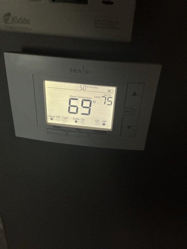 Completed comprehensive Supertune maintenance on a 5-year-old split system including both air conditioning unit and furnace. Performed full system inspection of outdoor condenser unit located in backyard at ground level and basement-mounted furnace. Conducted standard tune-up procedures including cleaning, testing, and adjusting both heating and cooling components. Verified thermostat operation showing 69°F room temperature with proper system controls functioning. Observed frost or crystalline buildup along ductwork seam joints, indicating possible condensation issue or refrigerant leak that may require future monitoring. Documented system conditions with photographs for service records. All equipment operational at time of service completion.