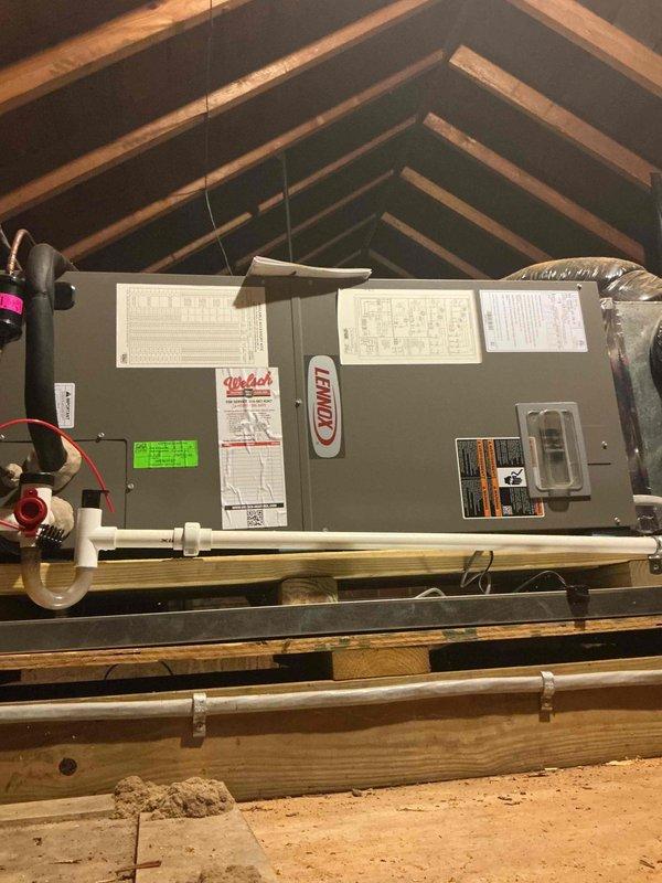 Completed comprehensive cooling system tune-up and preventative maintenance on two residential HVAC units, both under 10 years old. One unit located in attic space featured a Lennox air handler with proper installation on structural beams and adequate condensate drainage via PVC piping. Performed standard maintenance procedures including filter inspection, electrical connection verification, refrigerant level assessment, condensate drain line check, and overall system operation evaluation. Second unit serviced in side yard location. Both systems tested and confirmed operational with no deficiencies noted during inspection.