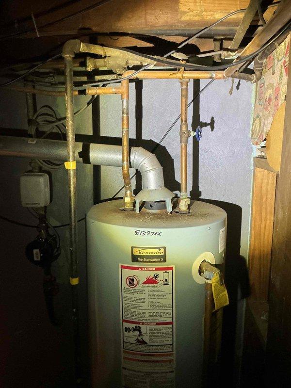 Responded to reported sewer line backup in basement during morning service call. Conducted thorough inspection of basement plumbing system, including existing Kenmore water heater and associated drainage connections. Performed diagnostic assessment of sewer line to identify source of backup issue. Documented current plumbing configuration with copper supply lines and PVC drainage components. Tested water pressure at exterior hose bib using calibrated gauge to evaluate overall system performance and rule out pressure-related factors contributing to drainage problems. Additionally provided estimate for tankless water heater installation as requested by property owner.