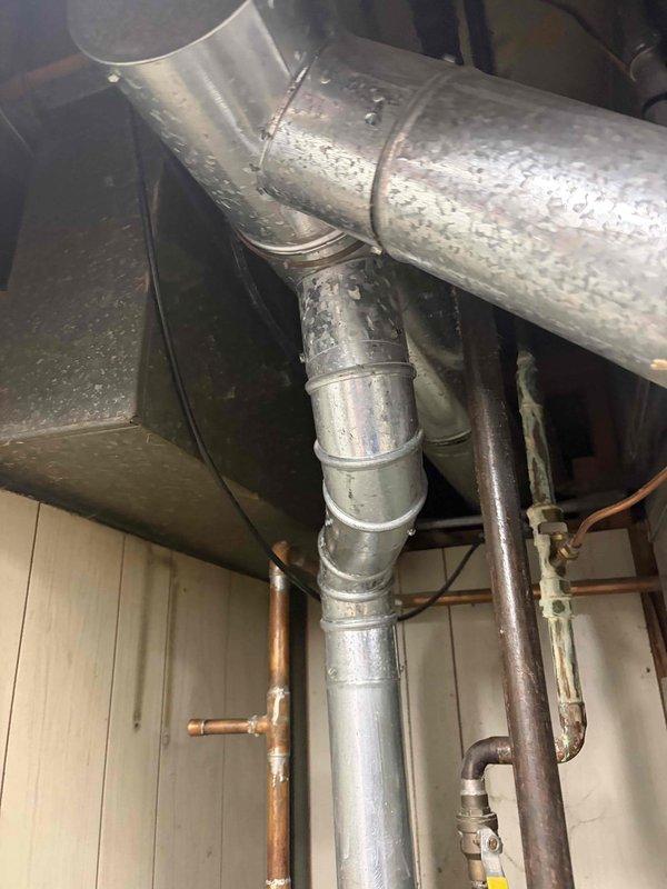 Completed comprehensive heating system tune-up on basement-located unit over 10 years old. Performed full inspection of HVAC components including heat exchanger fins, ductwork, and refrigerant lines; noted significant condensation on galvanized ductwork indicating proper system operation in heating mode. All mechanical components found to be functioning within normal parameters, system cleared for continued operation.