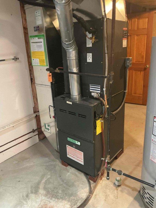 # O10 Tune-Up Completed - Single AC Unit

Performed comprehensive tune-up service on a 10-year-old residential air conditioning system located in basement utility room. Conducted full system inspection of furnace/air handler unit with integrated Aprilaire humidifier and APCO air purification system. Verified proper operation of all components, inspected ductwork connections and metallic supply/return runs for secure mounting and adequate sealing. Checked electrical connections at junction box, examined copper refrigerant lines for integrity, and assessed overall system performance. Cleaned accessible components, confirmed humidifier functionality, and documented equipment condition with photographic records. System operating within normal parameters with no immediate repairs required at time of service.