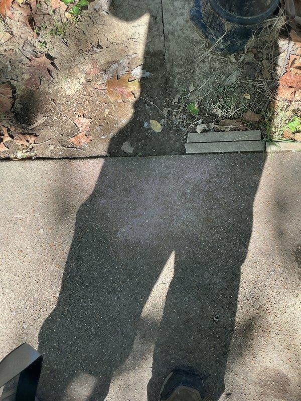 Conducted return site visit to assess switch location and evaluate mortar/concrete residue on paver surfaces for potential removal options. Documented existing conditions with photographs for follow-up remediation planning.
