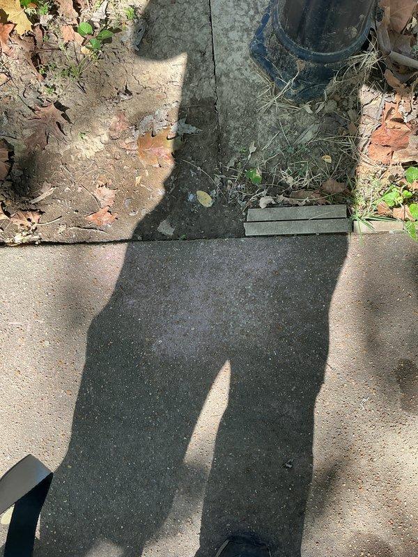 Conducted return site visit to assess switch location and evaluate mortar/concrete residue on paver surfaces for potential removal options. Documented existing conditions with photographs for follow-up remediation planning.