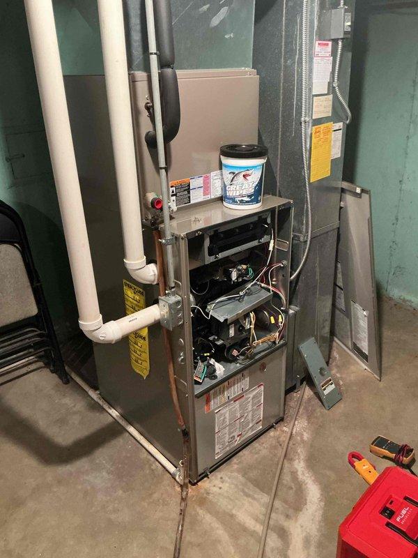 Performed comprehensive tune-up and inspection on 15-year-old Bryant furnace system per maintenance request. Accessed internal components through front panel to conduct thorough cleaning and safety checks of all mechanical, electrical, and combustion systems. Inspected blower motor assembly, heat exchanger, control boards, electrical connections, and wiring throughout unit. Verified proper operation of all safety controls, examined condensate drain lines and PVC venting system for proper configuration and drainage. Cleaned burner assembly and checked gas pressure. Tested all electrical components including transformer, relays, and control modules for proper voltage and function. System operating within manufacturer specifications upon completion of tune-up service.