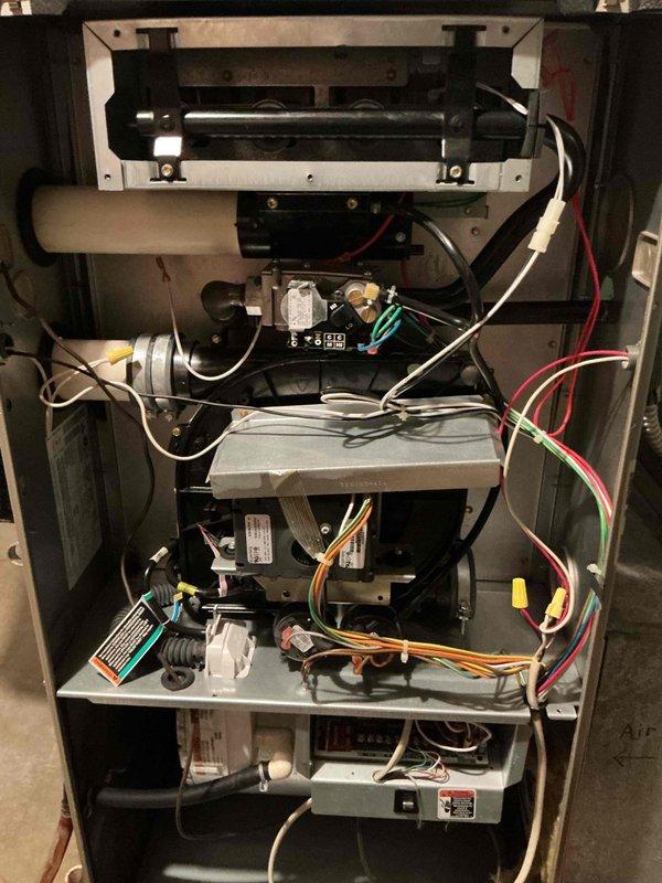 Performed comprehensive tune-up and inspection on 15-year-old Bryant furnace system per maintenance request. Accessed internal components through front panel to conduct thorough cleaning and safety checks of all mechanical, electrical, and combustion systems. Inspected blower motor assembly, heat exchanger, control boards, electrical connections, and wiring throughout unit. Verified proper operation of all safety controls, examined condensate drain lines and PVC venting system for proper configuration and drainage. Cleaned burner assembly and checked gas pressure. Tested all electrical components including transformer, relays, and control modules for proper voltage and function. System operating within manufacturer specifications upon completion of tune-up service.