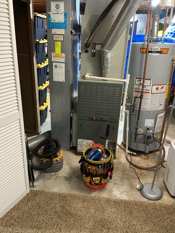 Completed annual heating maintenance and tune-up on a 20-year-old Trane furnace system. Performed comprehensive inspection of furnace components, verified proper operation of all safety controls, checked and cleaned burner assembly, tested ignition system, and inspected ductwork and connections. Additionally, removed vegetation growth from outdoor air conditioning unit condenser grille to ensure proper airflow and system efficiency.