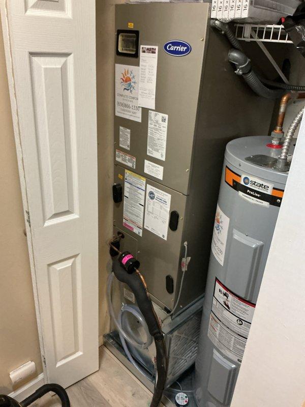 Completed preventive maintenance tune-up on Carrier furnace/air handler unit located in utility closet. Performed comprehensive system inspection, verified thermostat operation (Sensi model displaying proper temperature readings), and ensured all mechanical components were functioning within manufacturer specifications for optimal heating system performance.