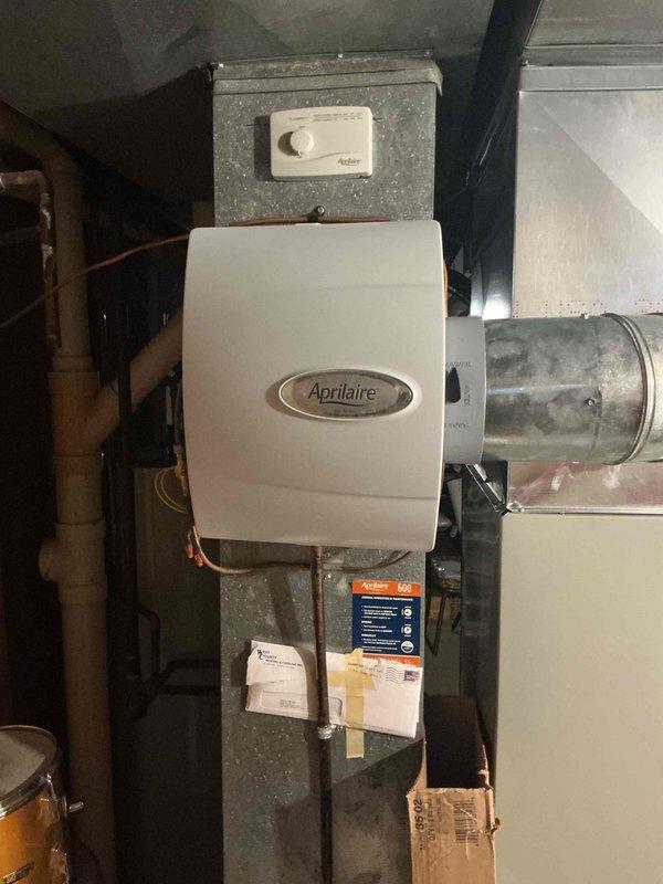 Completed comprehensive Super Tune maintenance service on single-zone residential HVAC system consisting of basement-mounted furnace with Aprilaire humidifier and ground-level condenser unit located on back side of home. Performed full system inspection, cleaned and tested all components, verified thermostat operation showing 80° display reading, inspected humidifier mounting and ductwork connections, and confirmed proper airflow throughout system. All equipment found in good operating condition with no immediate repairs required.