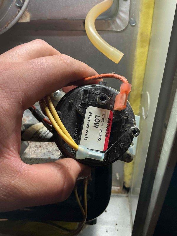Completed comprehensive tune-up and maintenance on a 12-year-old furnace system located in the basement. Performed standard maintenance protocol including inspection of all major components, burner assembly, heat exchanger, blower motor, and electrical connections. Inspected Honeywell motor assembly and associated wiring harnesses with multiple electrical connections confirmed secure. Identified significant condensation issues on metal ductwork with heavy frost and ice buildup on exterior surfaces, along with visible rust and corrosion on galvanized ducting indicating ongoing moisture infiltration and inadequate insulation. Documented deteriorated duct condition with oxidation present on multiple sections of vertical supply plenum. Recommended immediate attention to ductwork insulation and moisture control to prevent further corrosion and improve system efficiency. System operational at time of departure with all safety controls functioning properly.