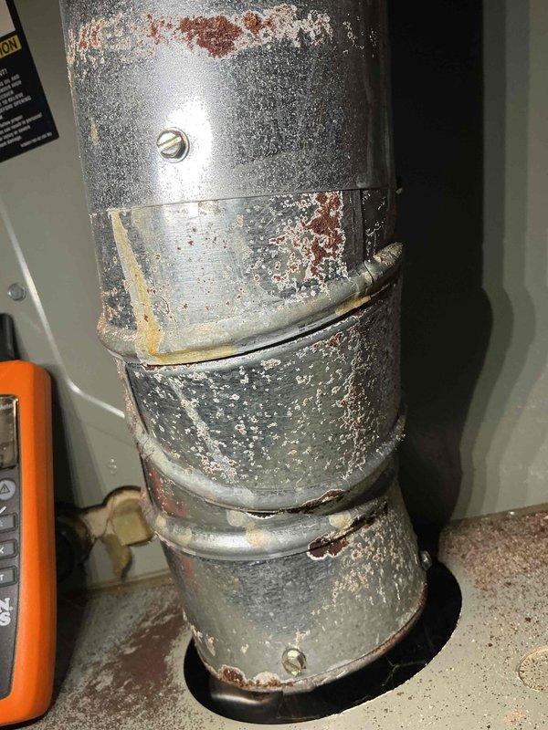 Completed comprehensive tune-up and maintenance on a 12-year-old furnace system located in the basement. Performed standard maintenance protocol including inspection of all major components, burner assembly, heat exchanger, blower motor, and electrical connections. Inspected Honeywell motor assembly and associated wiring harnesses with multiple electrical connections confirmed secure. Identified significant condensation issues on metal ductwork with heavy frost and ice buildup on exterior surfaces, along with visible rust and corrosion on galvanized ducting indicating ongoing moisture infiltration and inadequate insulation. Documented deteriorated duct condition with oxidation present on multiple sections of vertical supply plenum. Recommended immediate attention to ductwork insulation and moisture control to prevent further corrosion and improve system efficiency. System operational at time of departure with all safety controls functioning properly.